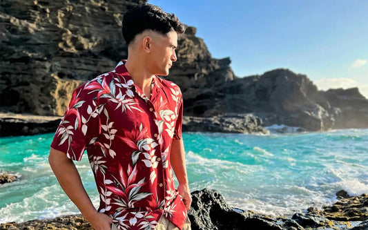 A Young man giving a pose with floral Hawaiian shirt on the beach  