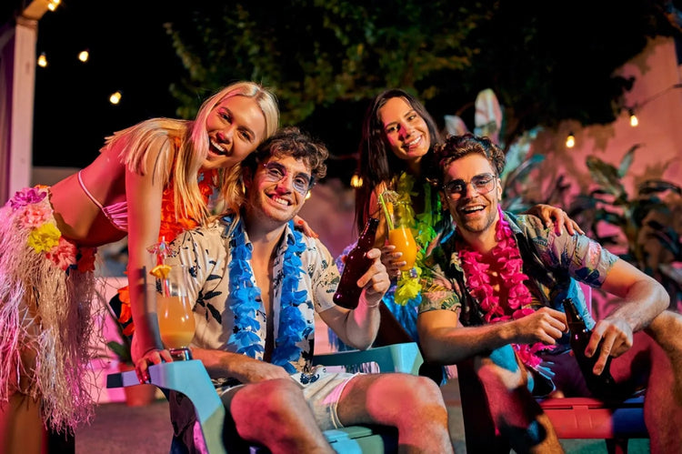 A group of friends are enjoying a Hawaiian feast while wearing Hawaiian shirts