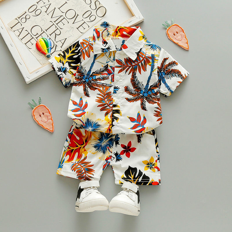 Two-piece summer clothing set for children. Shirt features a colorful floral design, paired with coordinating shorts.