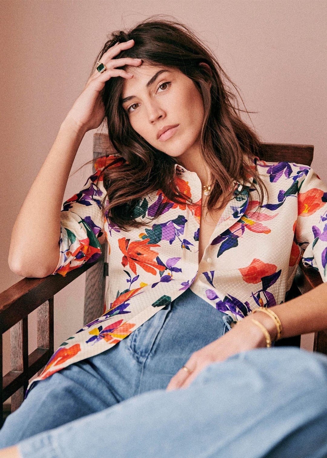 Breezy and bold: woman rocks a floral print Hawaiian shirt with long sleeves.
