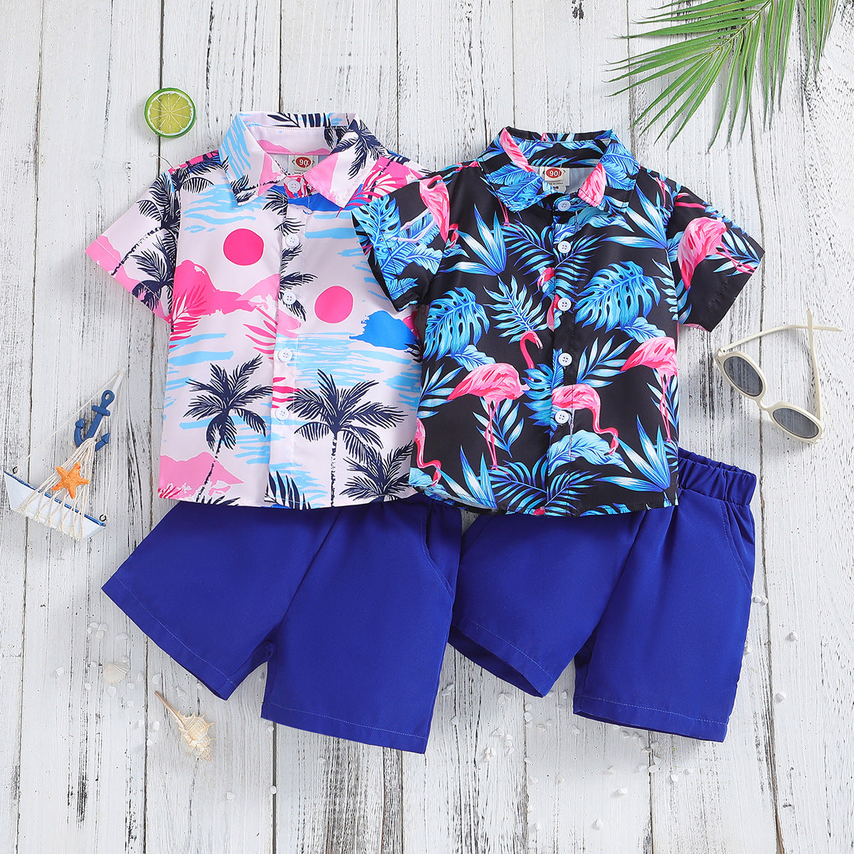 Two-piece summer outfit for boys featuring a short-sleeved shirt with a colorful summer print and coordinating shorts. 