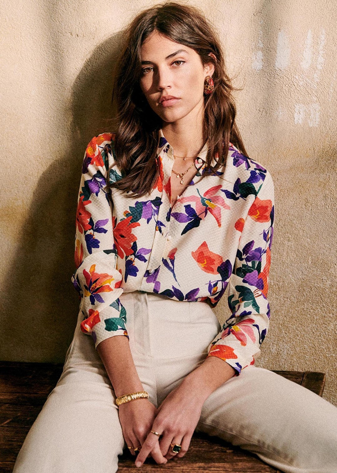Island vibes with a twist: woman in a long-sleeved floral Hawaiian shirt.