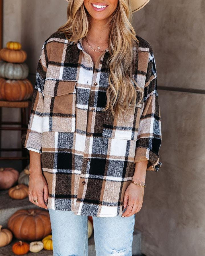 Comfy Plaid Getaway: Loose-fitting plaid shirt offers effortless style for relaxed beach days. 