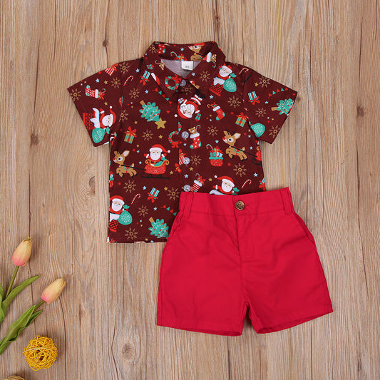 Two-piece Christmas costume for boys featuring a shirt with a festive cartoon design and coordinating pants or shorts.