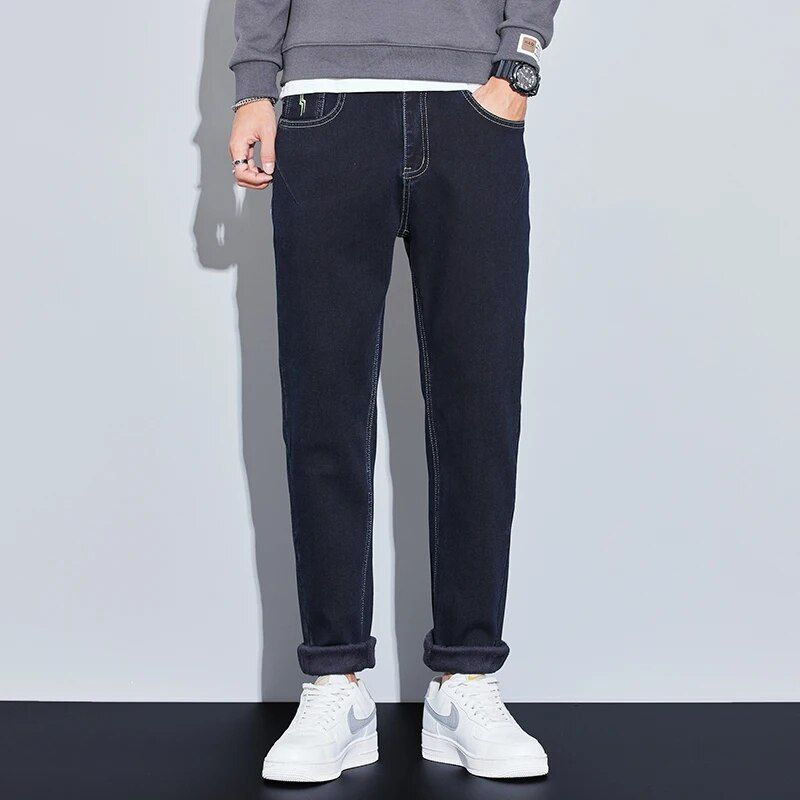 Fashionable men's winter fleece-lined slim fit jeans, offering both style and warmth for casual wear